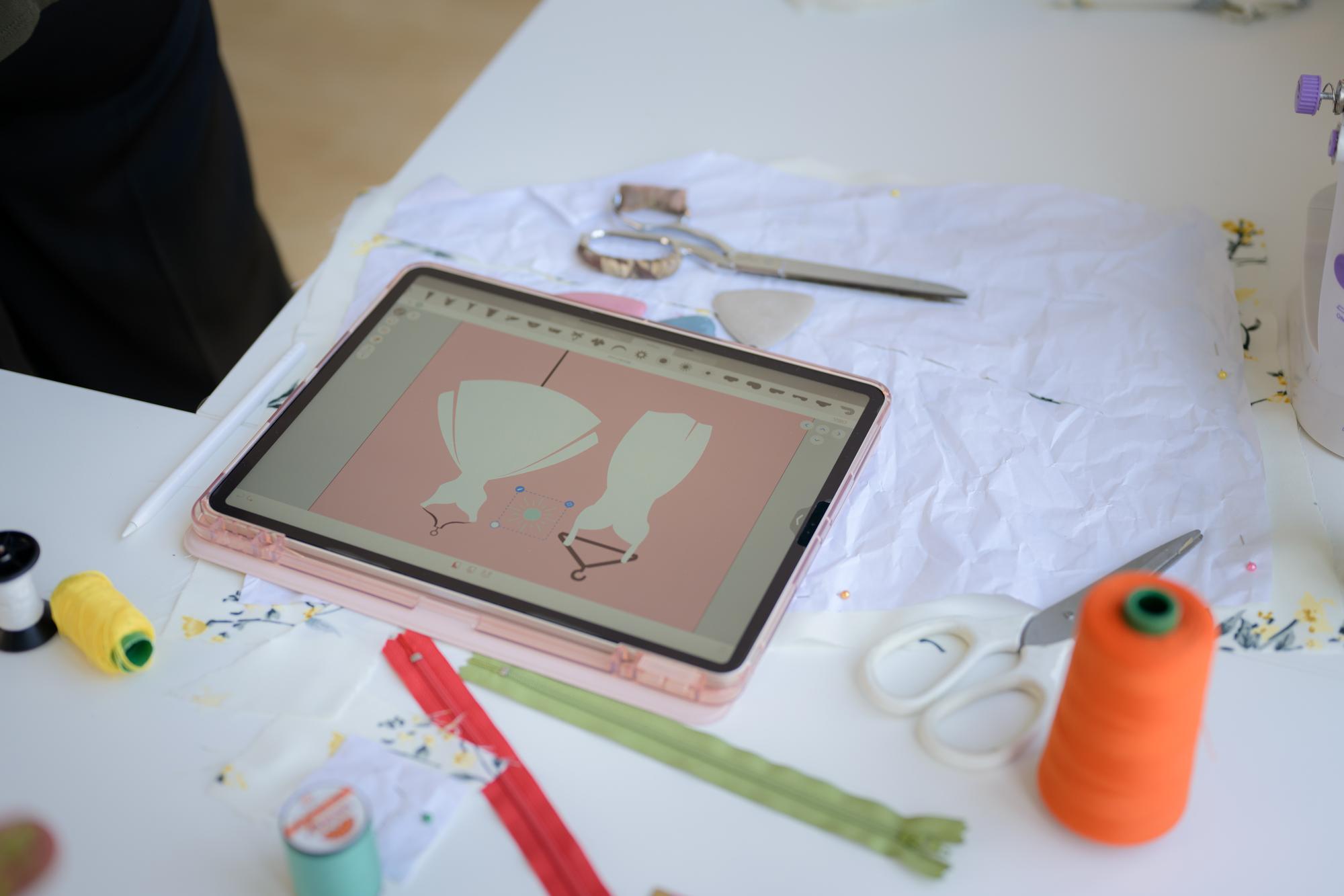 Close-up modern embroidery machine and digital pattern on tablet